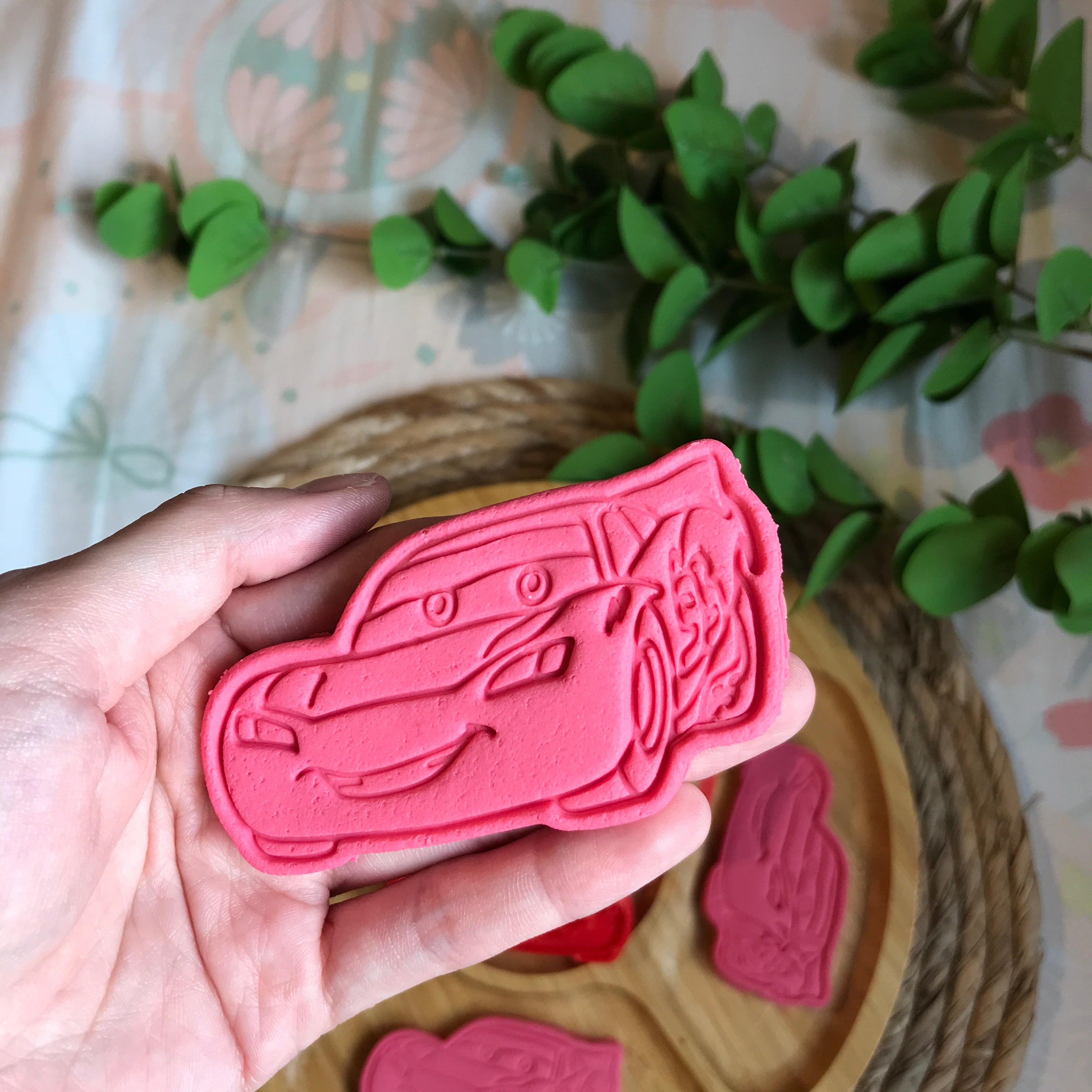 Playdough creation of a red color Lightning McQueen car.
