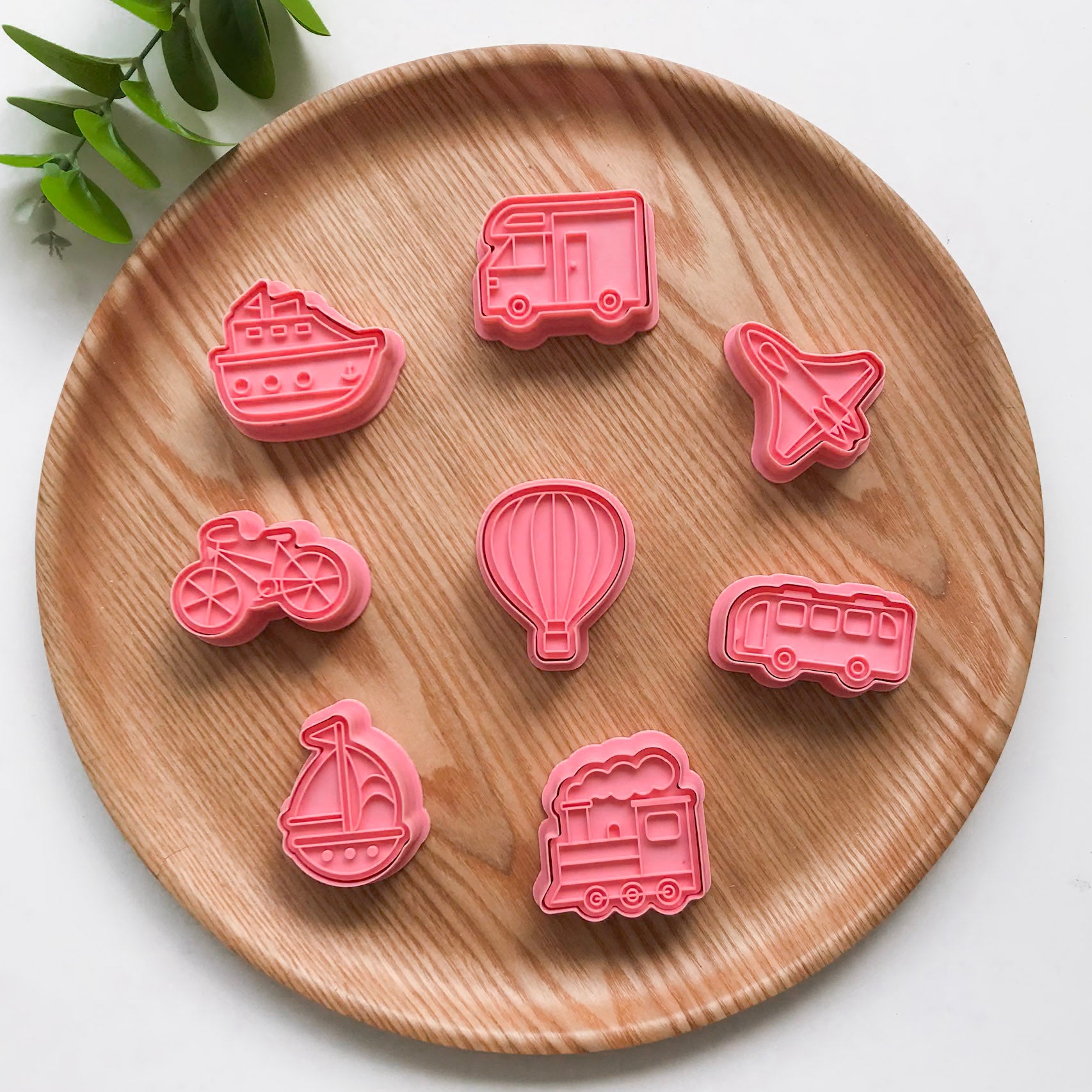 A set of 8 playdough vehicle themed cutters featuring a truck, boat, bicycle, ship, airplane, hot air balloon, train and bus.