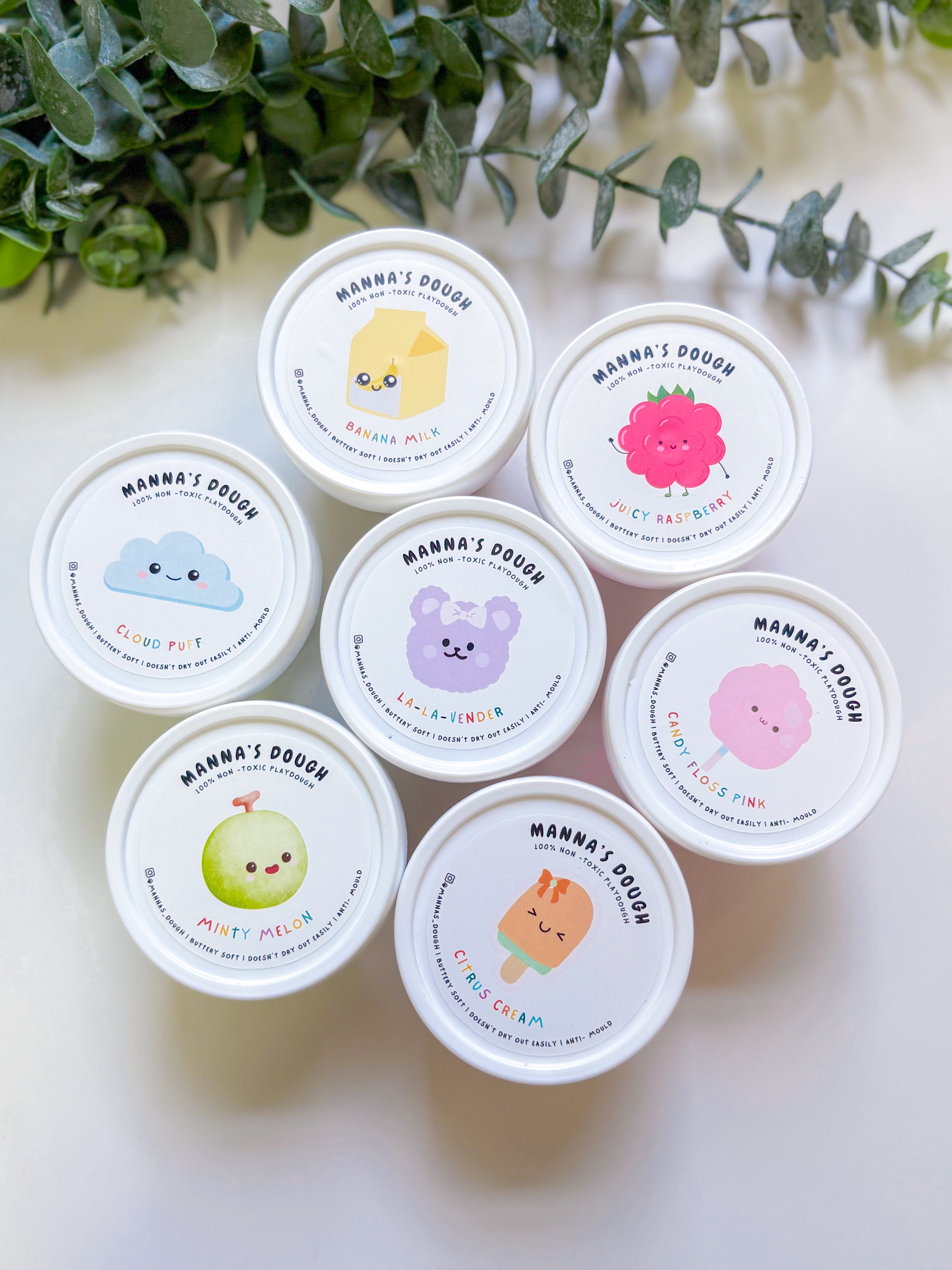 Set of small containers with colorful labels featuring cartoon characters on a light background.
