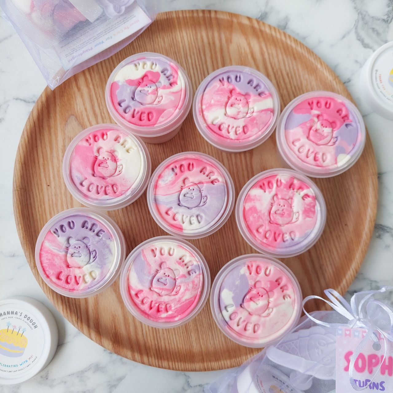 A set of 9 marbled playdough tubs