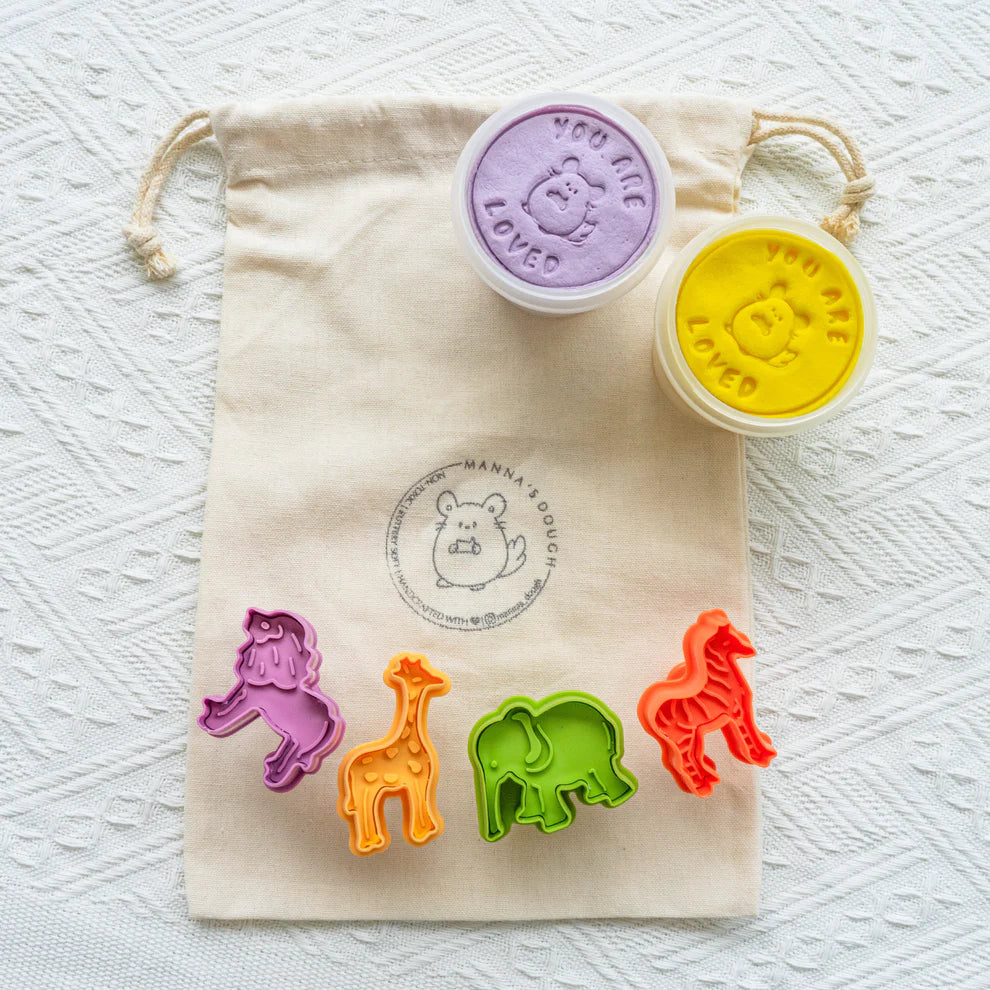 Set of colorful animal-shaped cookie cutters with two stampers on a branded drawstring bag.