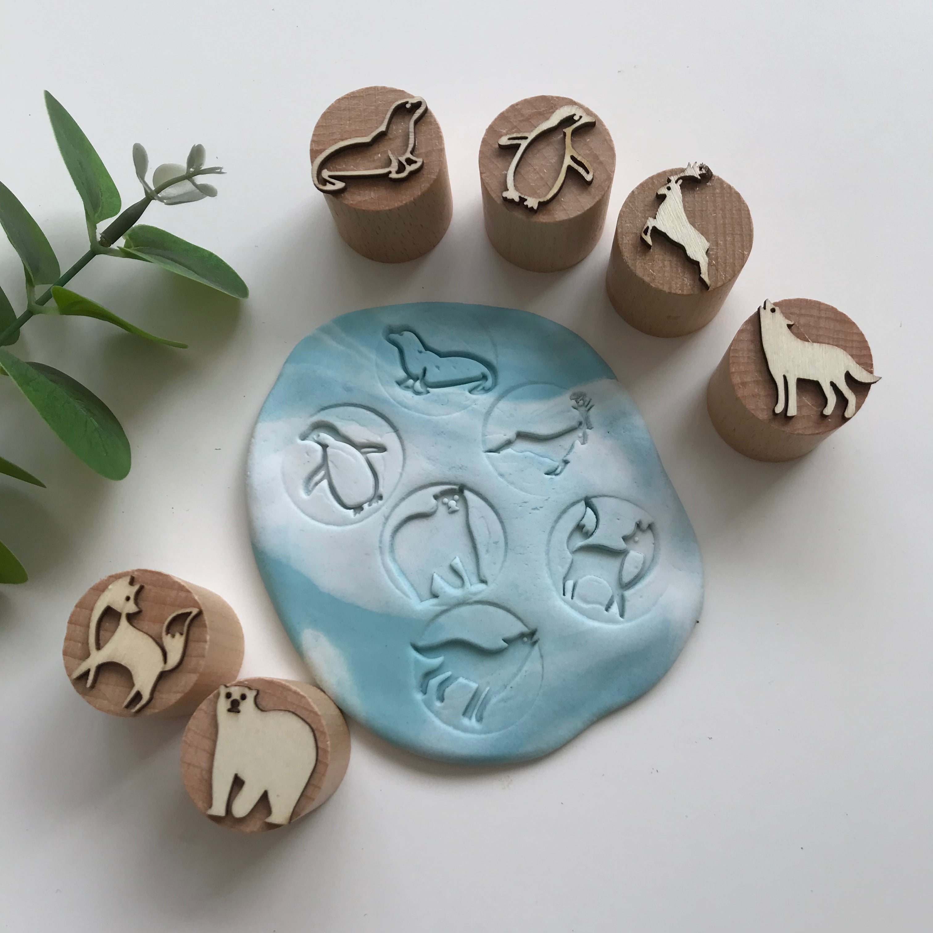Set of 6 wooden playdough stampers featuring an artic theme. The designs on the stampers are - fox, bear, seal, penguin, deer, wolf