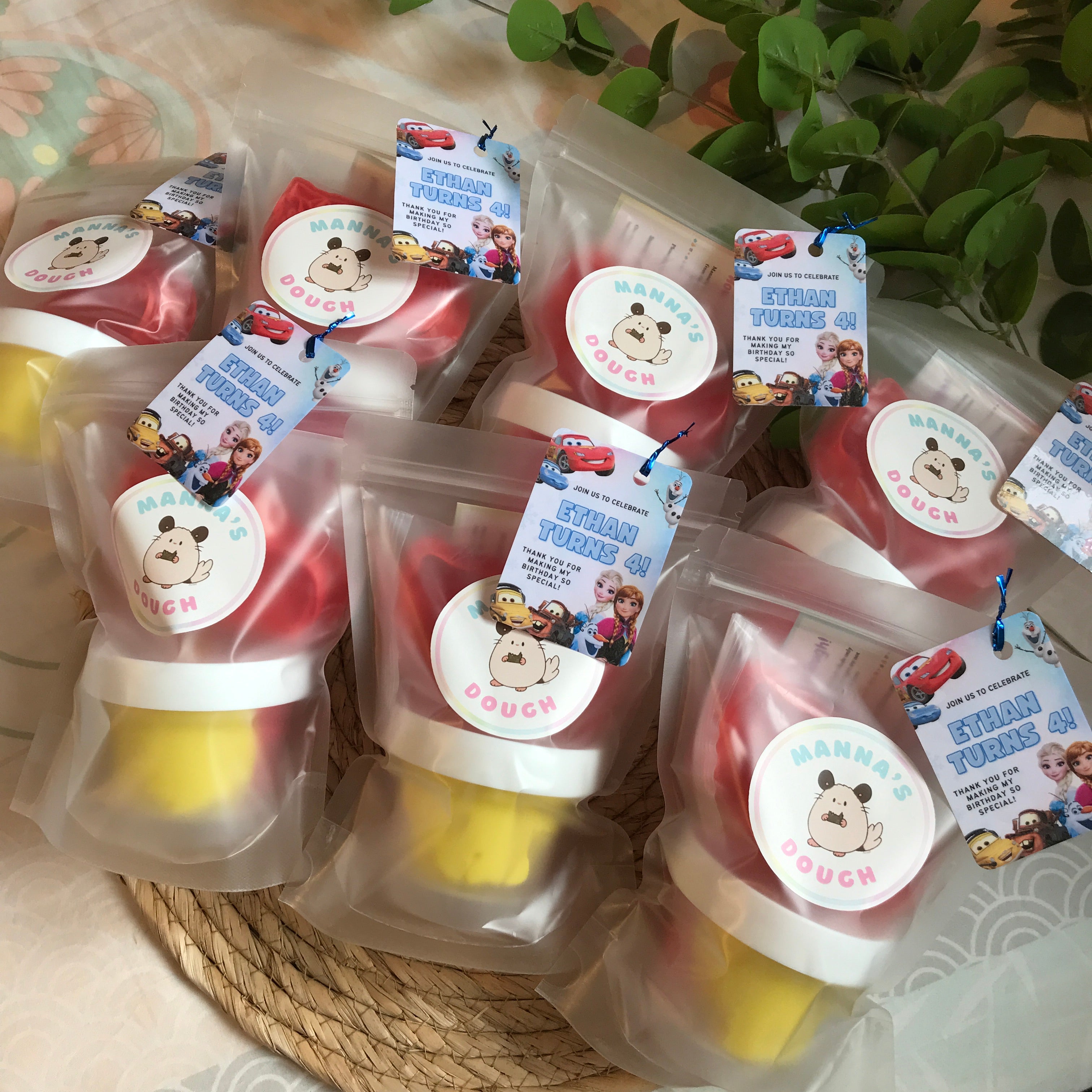 Lightning McQueen Playdough party packs. Each pack has one tub of playdough, a playdough cutter and a lightning Mcqueen Gift tag, alongside the Manna's Dough logo packaged in a frosted bag 