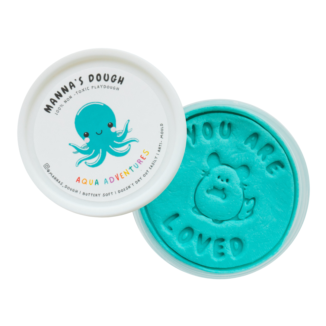 Bright turquoise playdough from Manna's Dough, labeled 'Aqua Adventures' with a cute octopus design on the lid. The playdough is stamped with 'YOU ARE LOVED' and an adorable animal character, perfect for kids' creative fun.