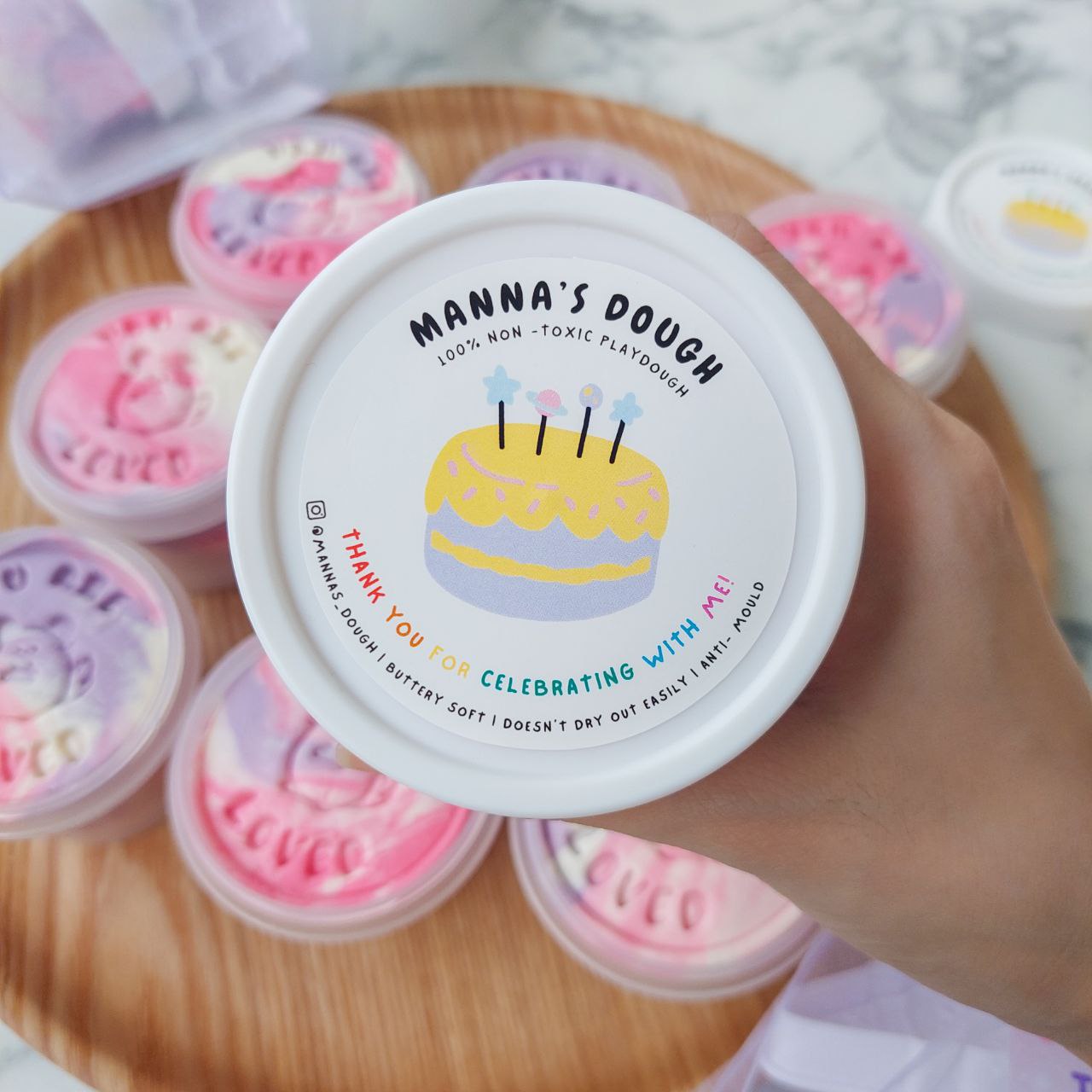 A playdough tub with a happy birthday sticker