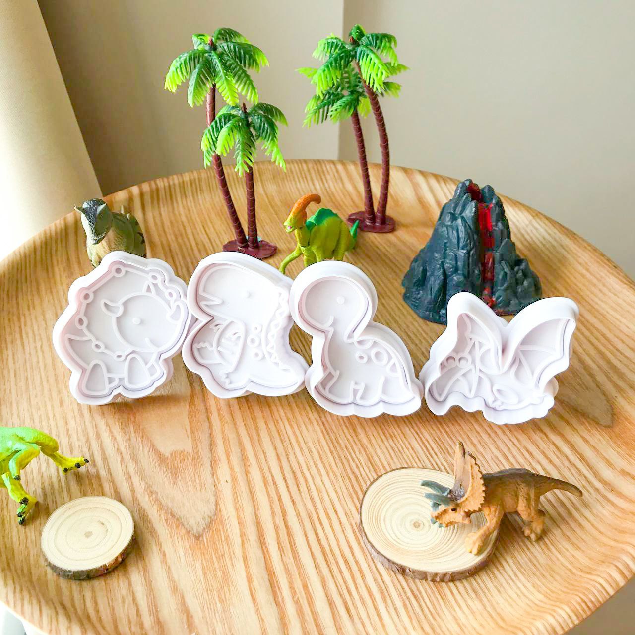 A set of 4 dinosaur playdough cutters